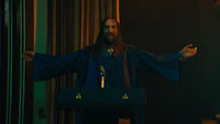 a man in a blue robe with his arms outstretched