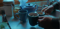 a person pouring tea into a cup