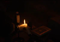 a person is holding a candle in the dark