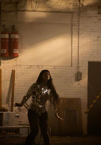 a woman is dancing in a dark room