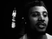 a black and white photo of a man standing in front of a boxing bag