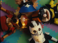a group of puppets are laying on a colorful floor