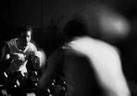 a black and white photo of a man in a gym