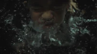a man is swimming in the water with his mouth open