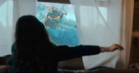 a girl is standing in front of a window looking at a monster