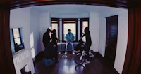 a group of people standing in a room with a bicycle
