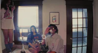 a group of people in a bathroom smoking a cigarette