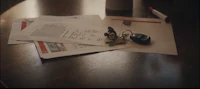 a stack of papers and keys on a table